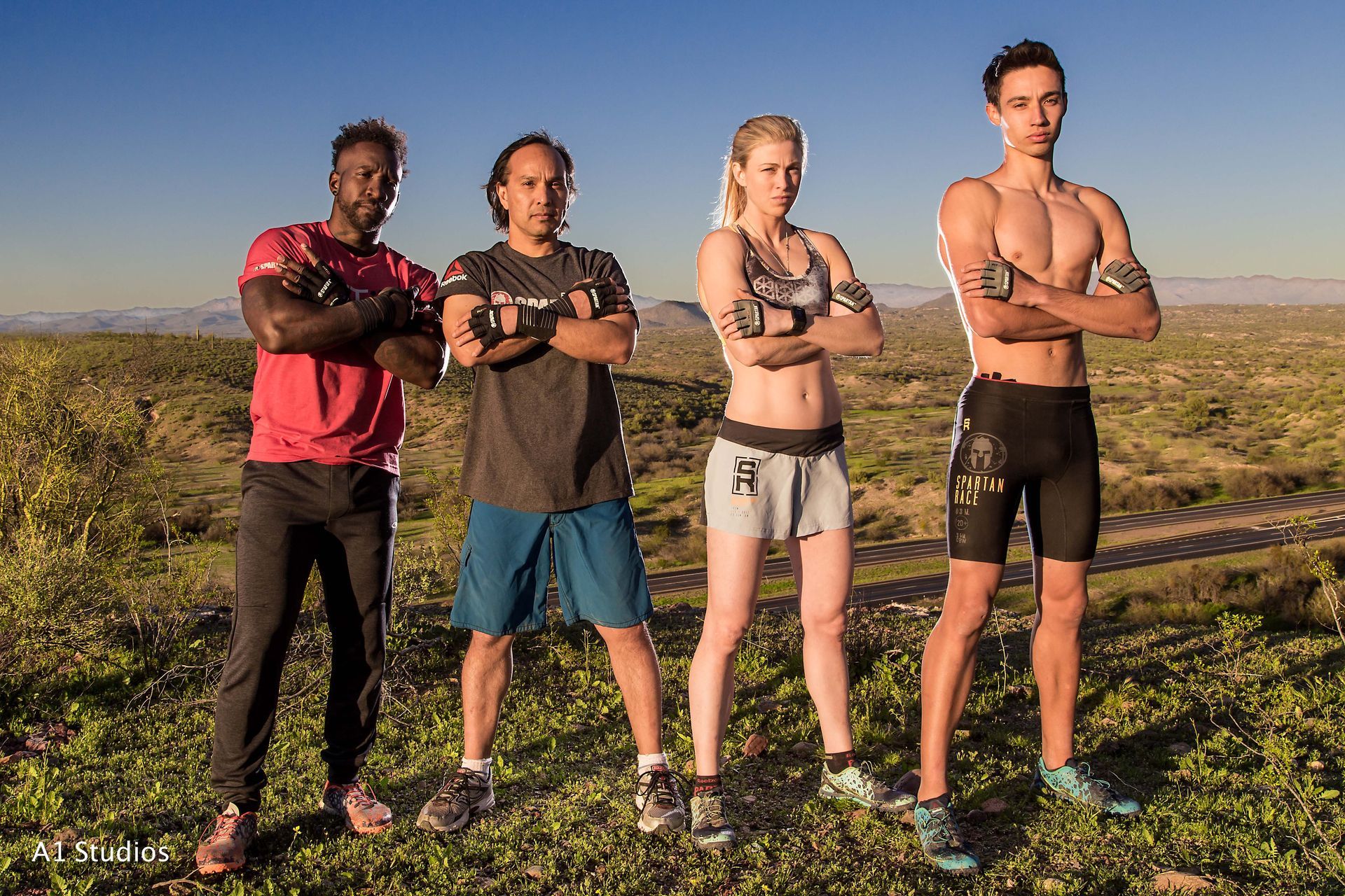 A group of people standing in a field with their arms crossed