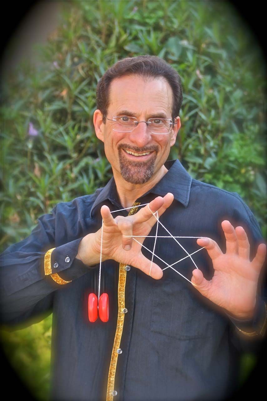 A man in a black shirt is holding a red yo yo in his hands.