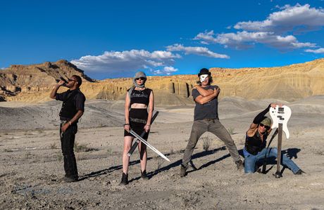 A group of people are posing for a picture in the desert.