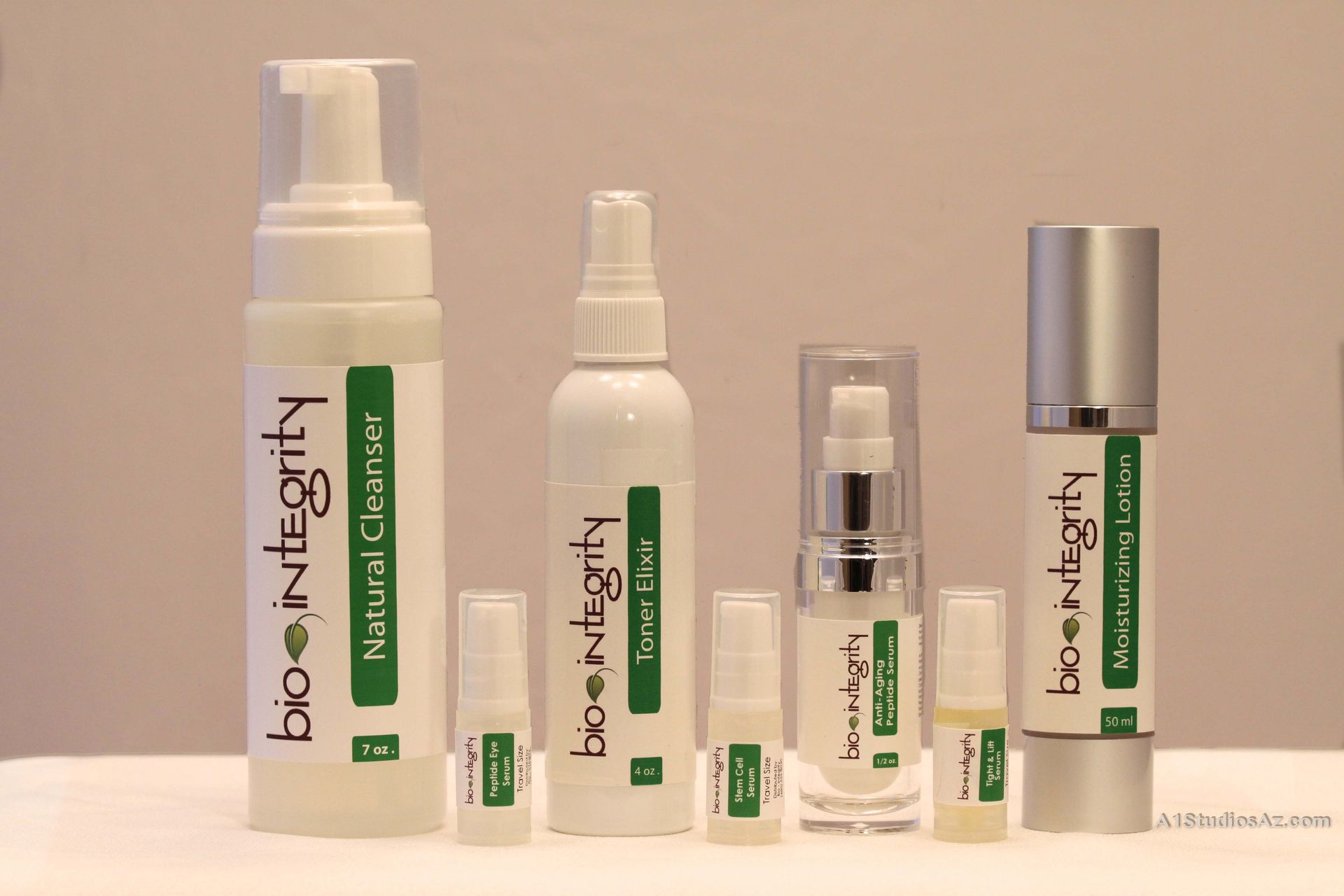 Several bottles of bio integrity products are lined up on a table