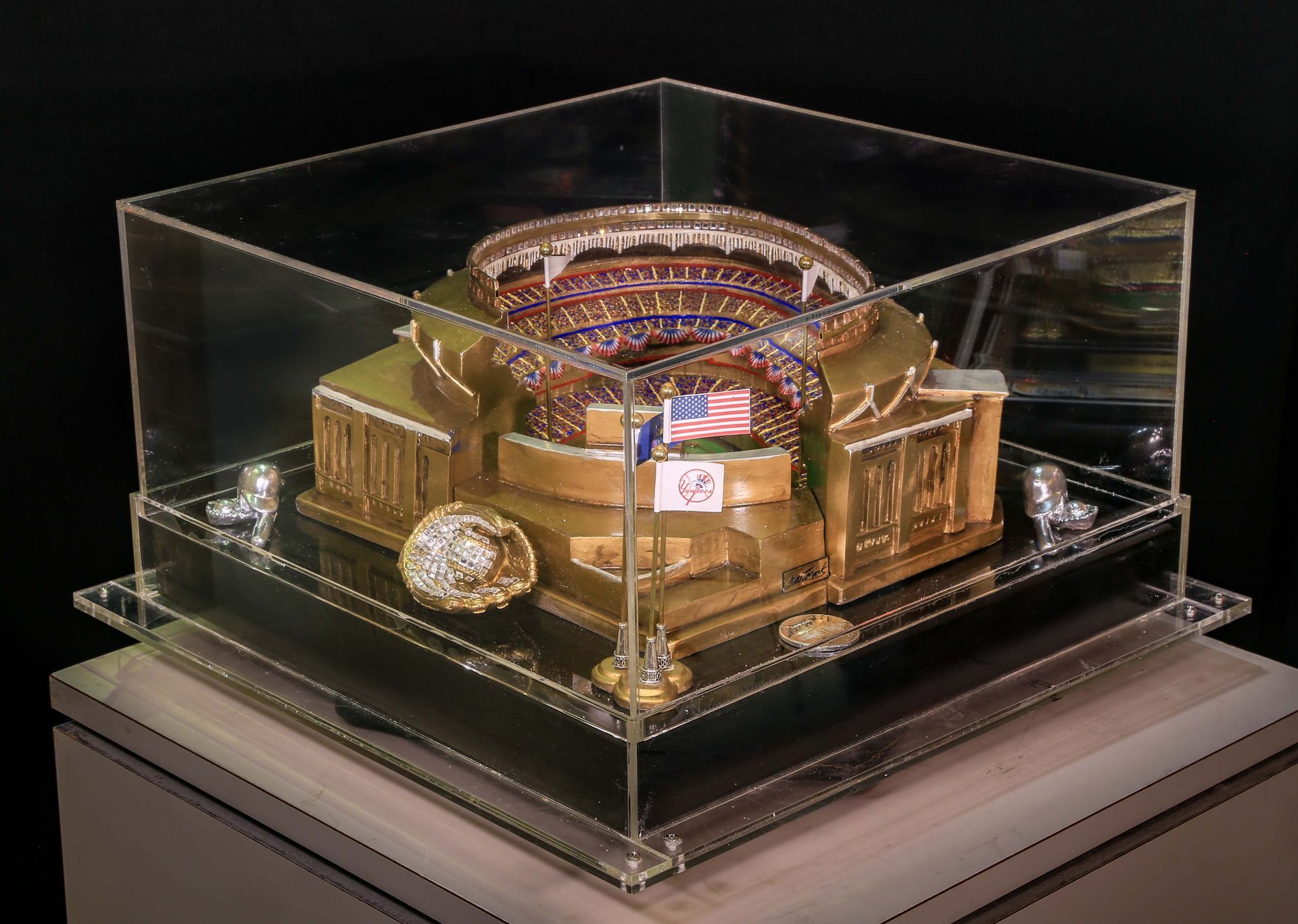A model of a baseball stadium is in a clear display case.