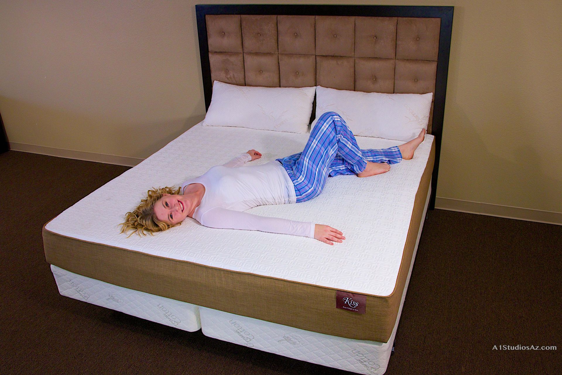 A woman is laying on her stomach on a bed.