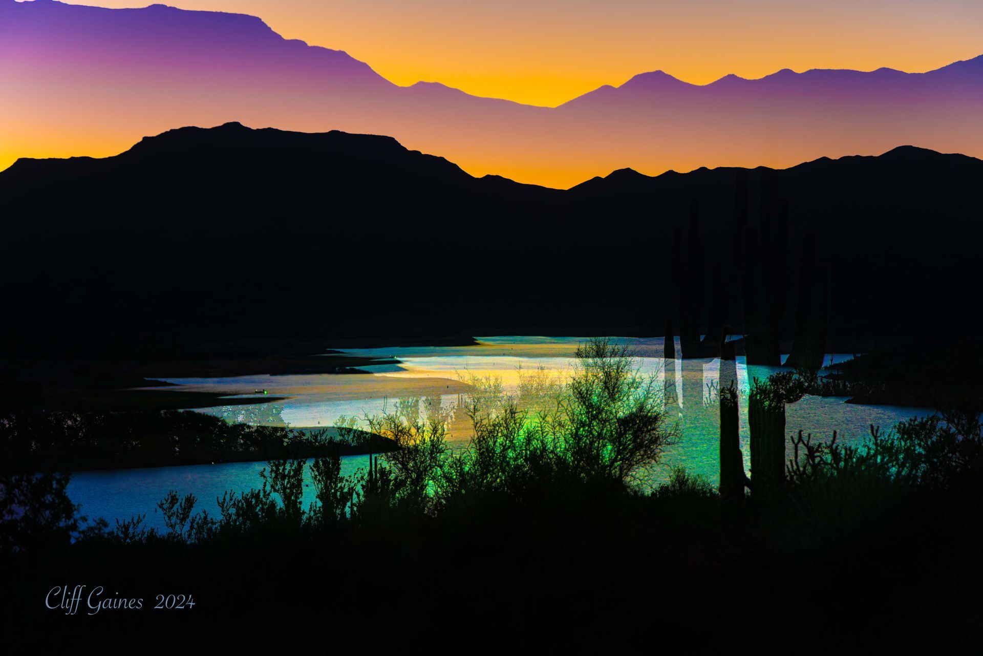 A sunset over a lake with mountains in the background