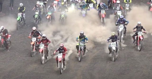 A group of people are riding dirt bikes on a dirt road.
