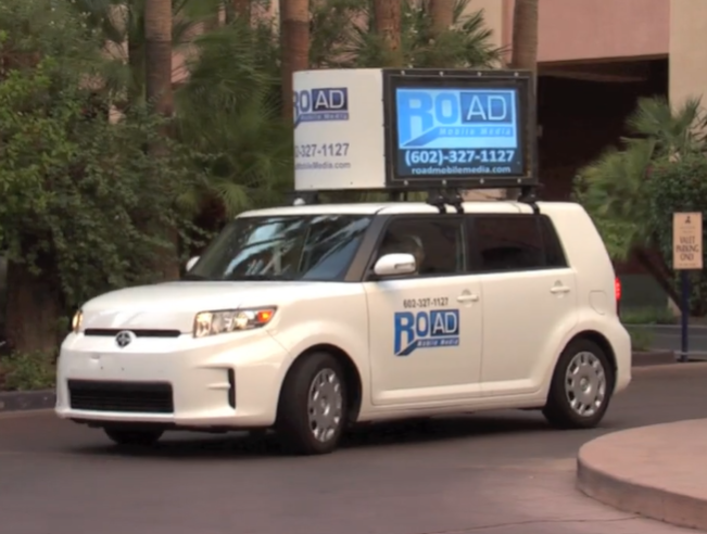 A white car with the word road on the side