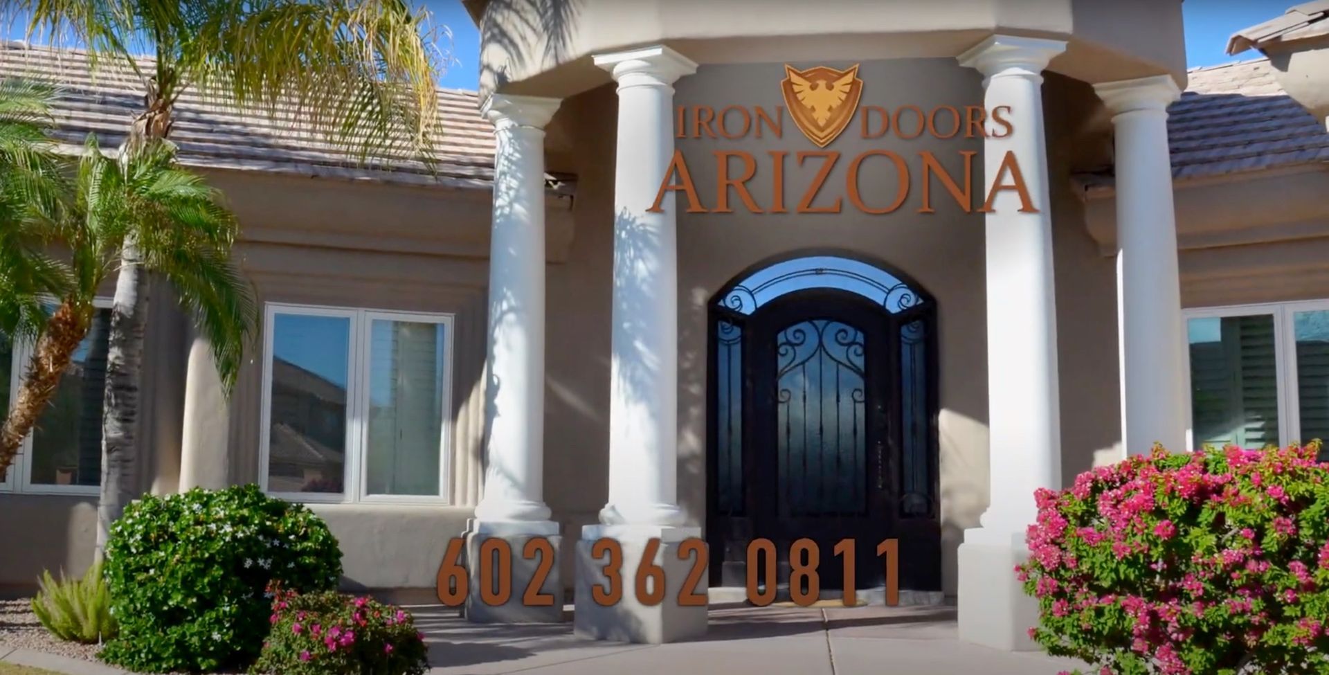 The front of a house in arizona with a wrought iron door