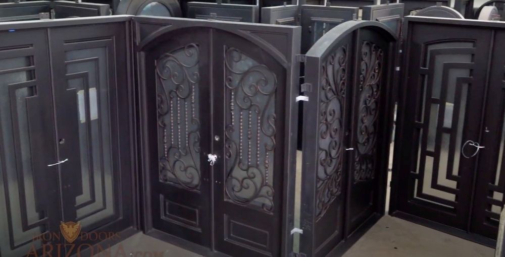 A bunch of wrought iron doors are sitting on top of each other.