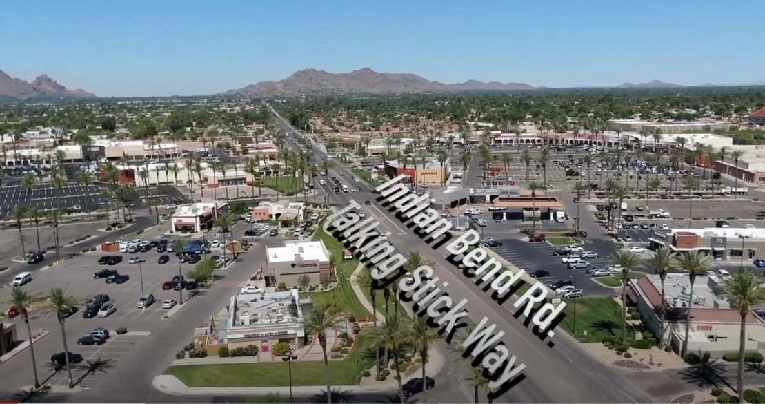 An aerial view of a city street with a sign that says talking stick way
