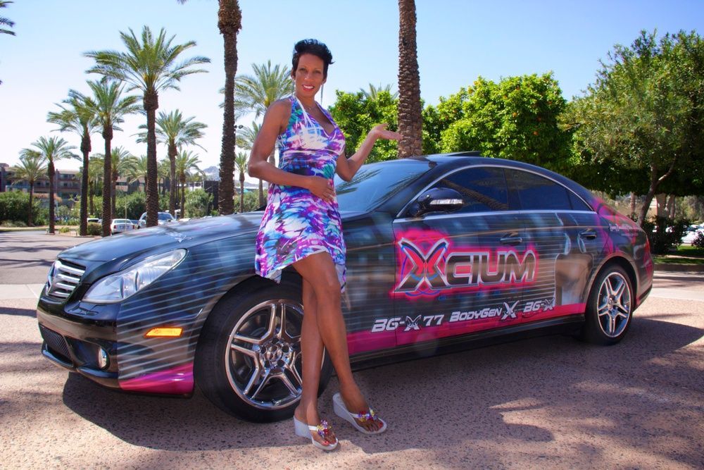 A woman standing next to a car that says xfilm