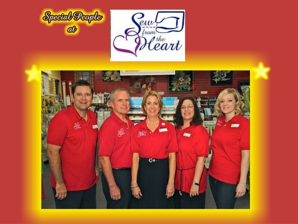 A group of people standing in front of a sign that says see from the heart