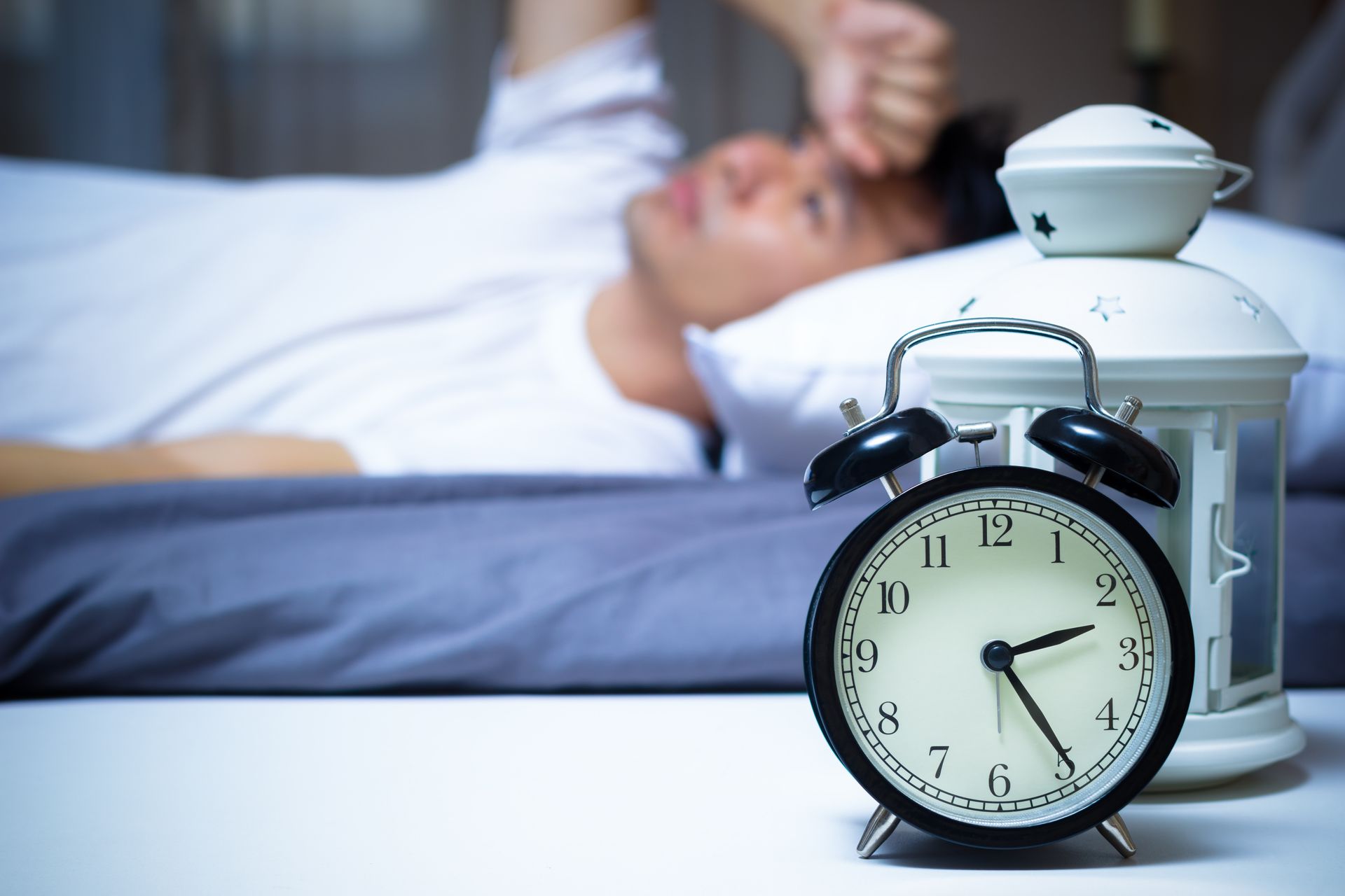 Man sleeping with an alarm clock