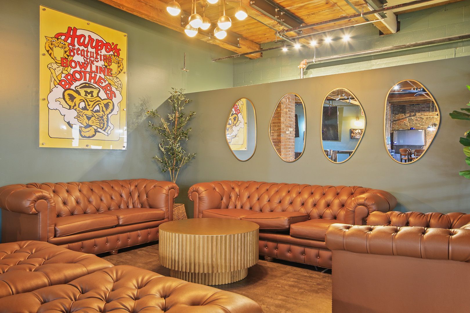 A living room filled with brown couches and a coffee table.