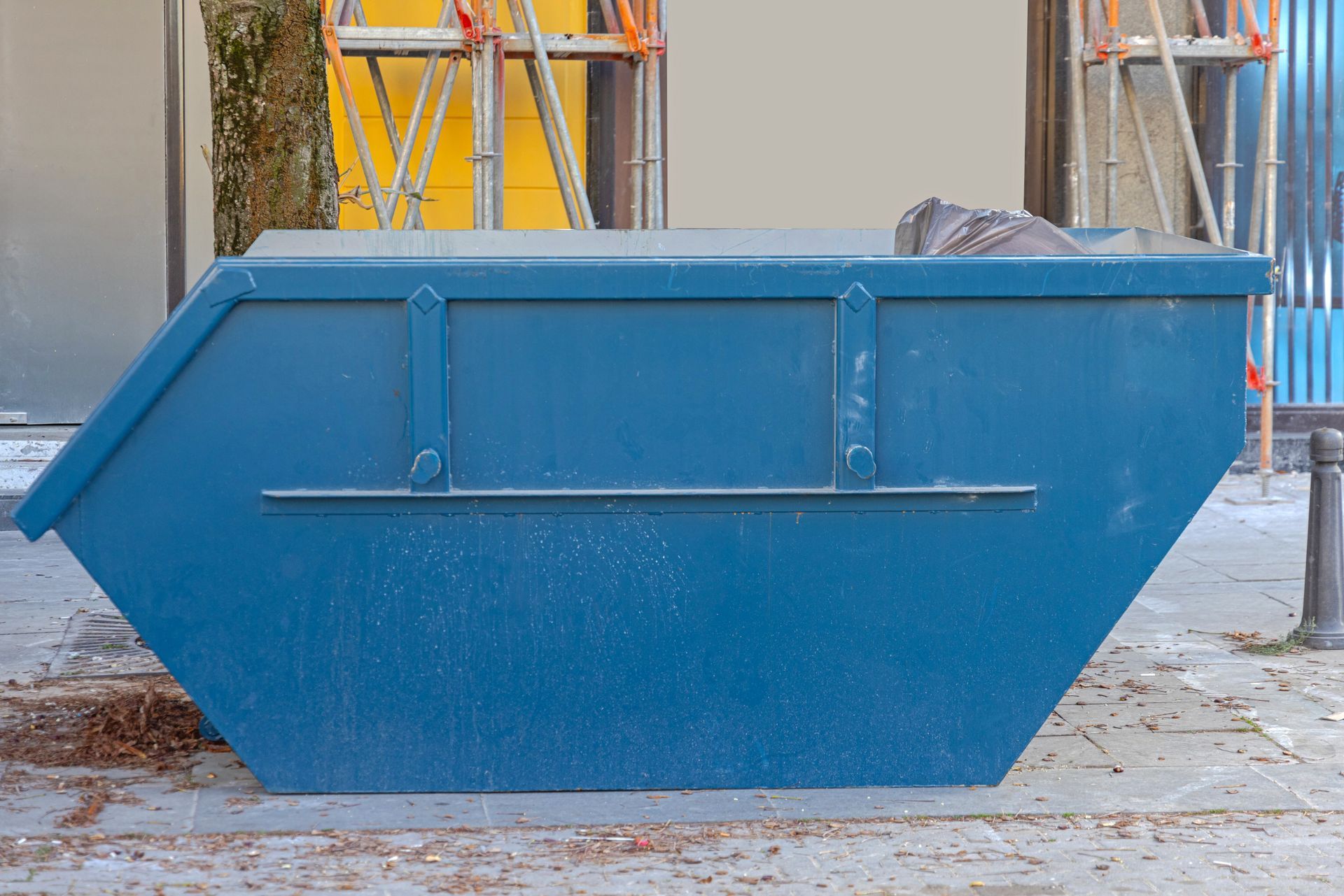 Blue Dumpster on A City Sidewalk, Containing Some Trash — UBIN in Broadwater, NSW