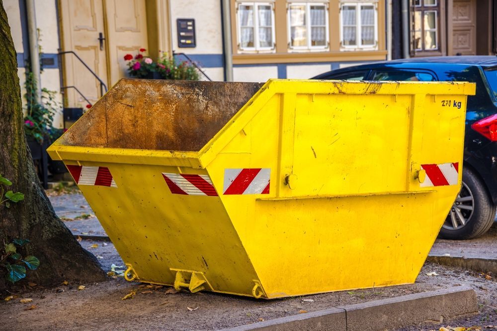 Yellow Dumpster on A City Street, with Red and White Diagonal Safety Stripes — UBIN in Lismore, NSW