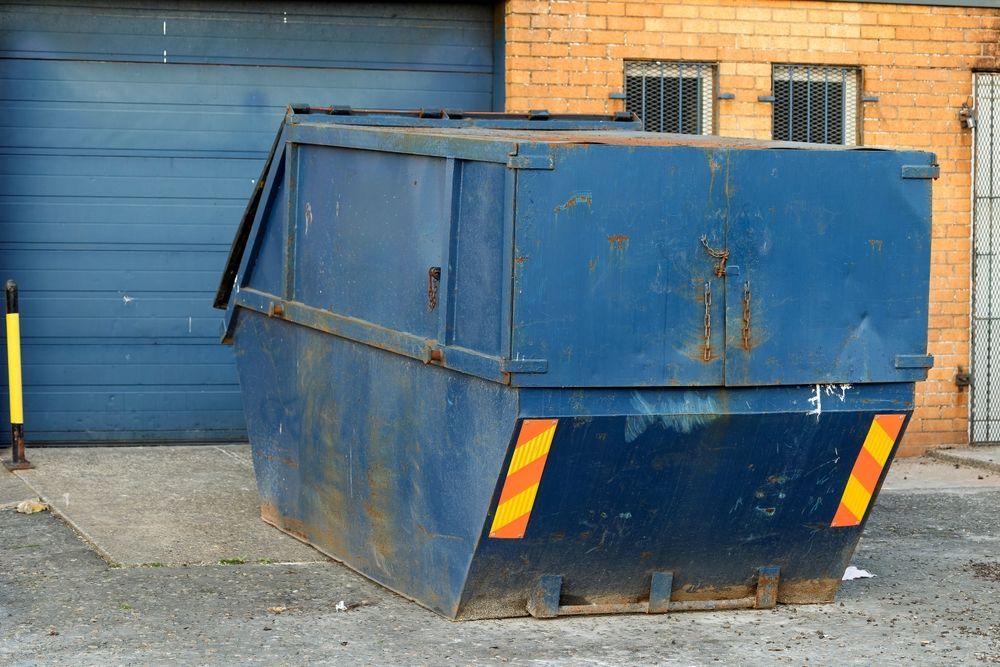 Blue Dumpster Near a Loading Dock, with Safety Stripes, Brick Building in Background — UBIN in Casino, NSW