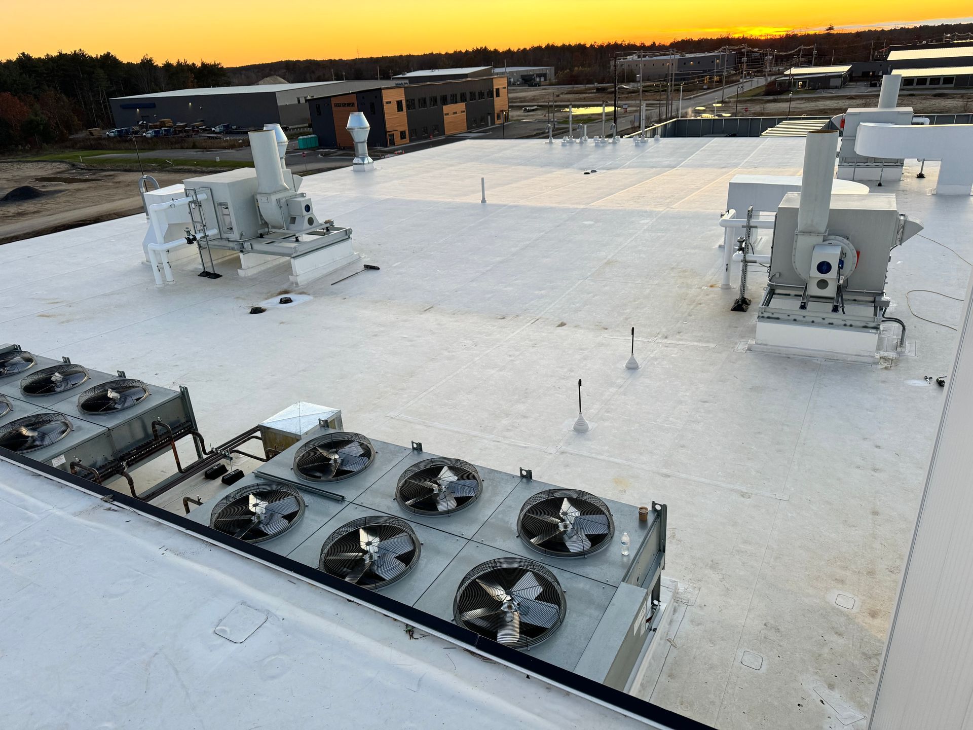 A white roof with a lot of fans on it