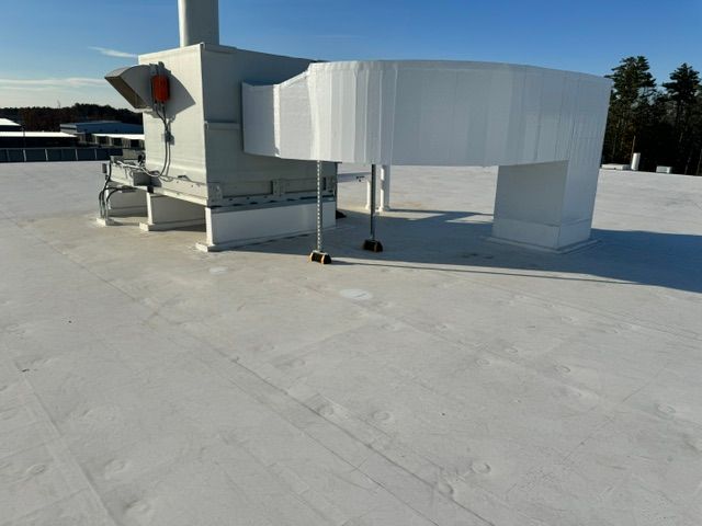 A white roof with a chimney on top of it