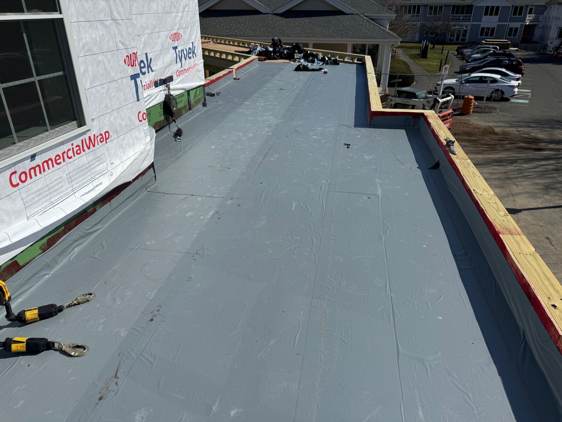 A man is laying on the roof of a building.