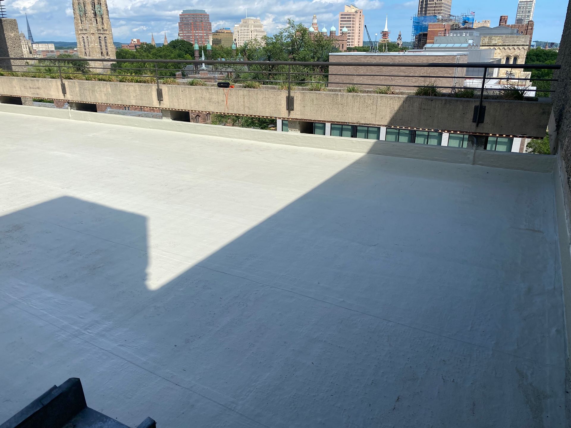 An empty rooftop with a view of a city.