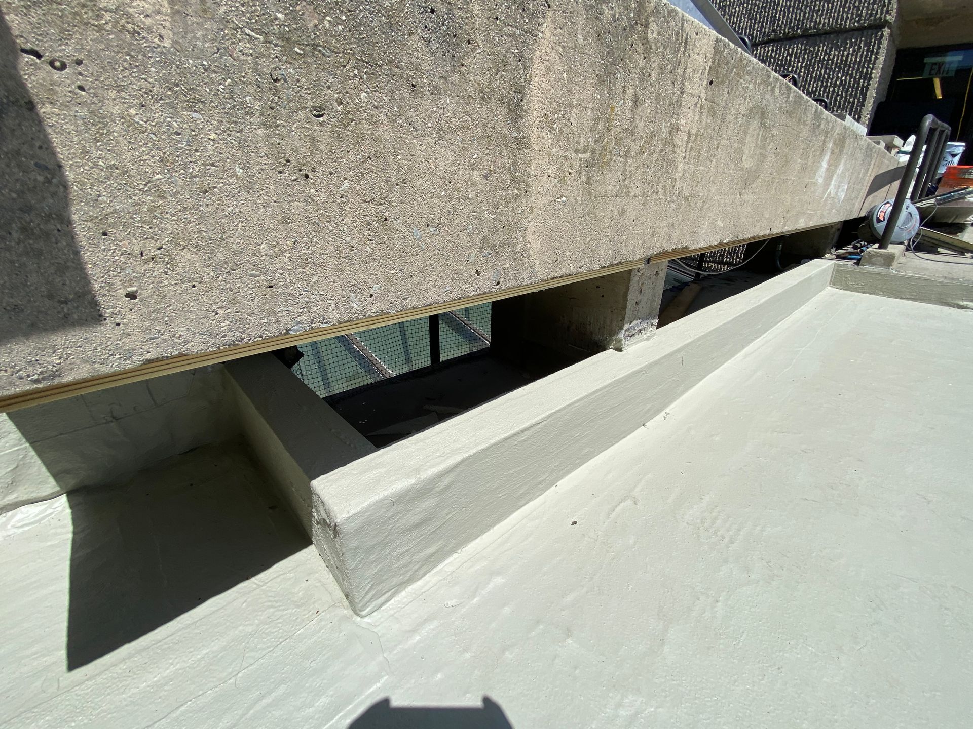 A close up of a concrete surface with a shadow on it.