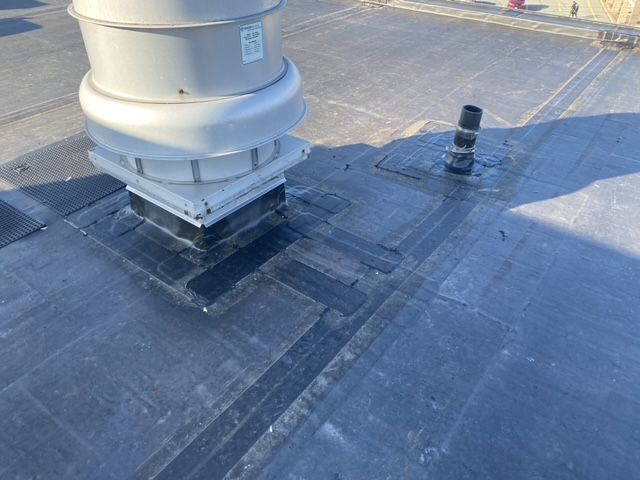 There is a chimney on the roof of a building.