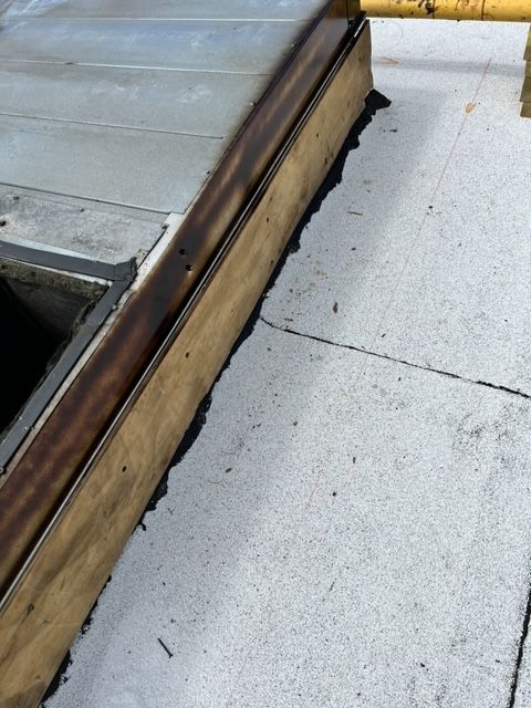 A white tile floor with a wooden border