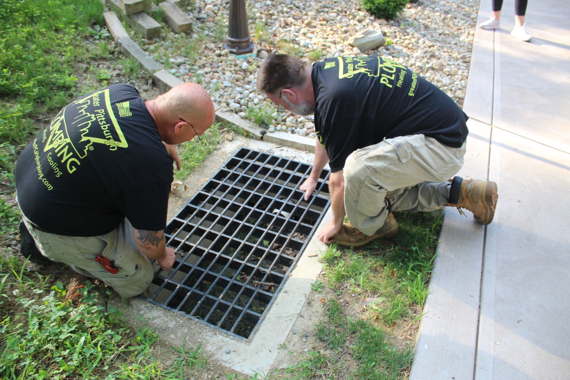 A person is holding a camera over a toilet.