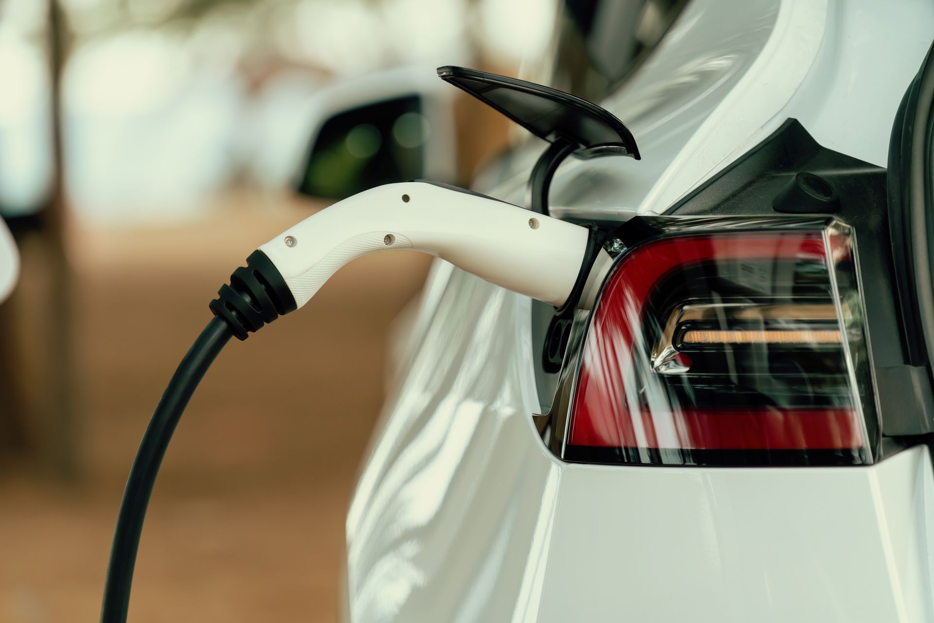 An electric car is being charged at a charging station.