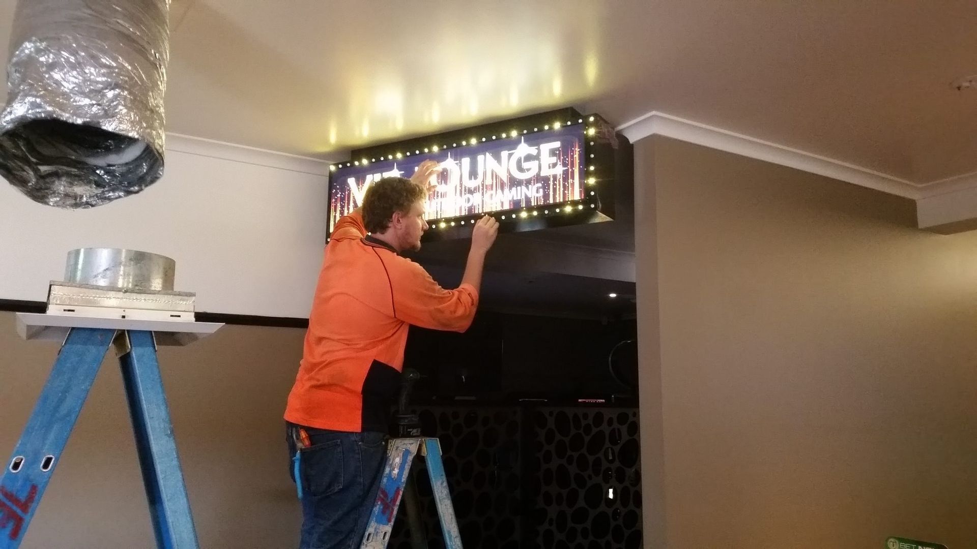 Emergency Electrician Adjusting a Digital Sign