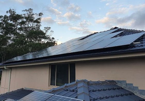 Row Of Blue Solar Panels On Orange Roof — 7E Integrated Services In Port Stephens NSW