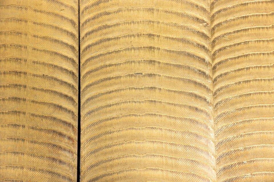 Beige fabric with textured horizontal lines, forming three vertical sections.