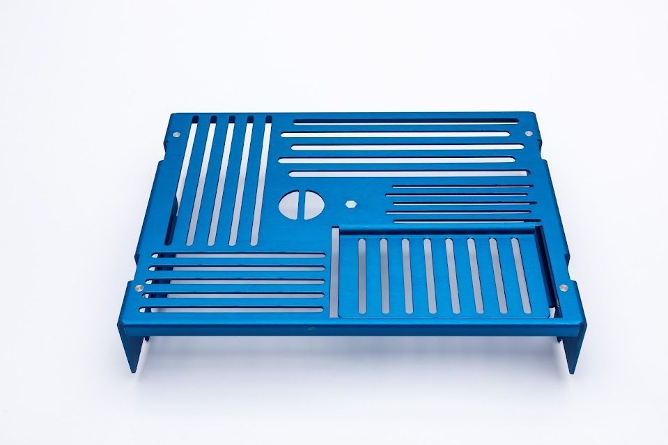 Blue metal tray with slotted sections and legs.