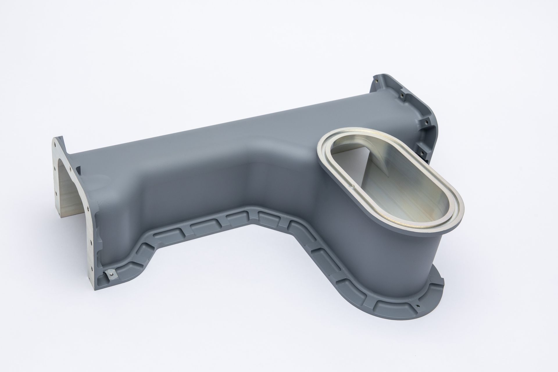 Gray metal duct with rectangular and oval openings.