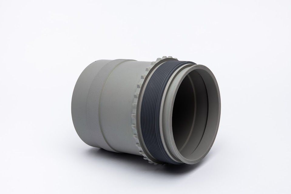 Gray cylindrical object with a textured, dark gray band.