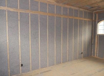 A room with a lot of gray walls and a window.