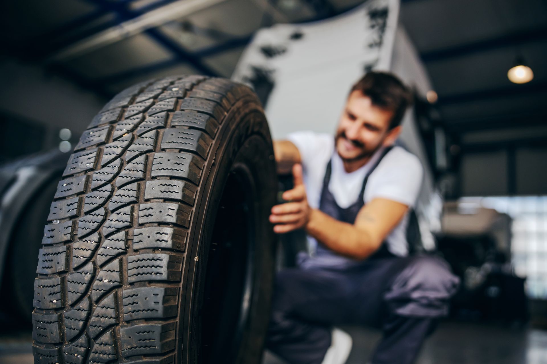 man pushing tire | Kirkham Automotive