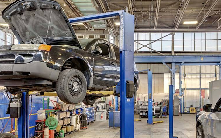 black suv on lift | Kirkham Automotive