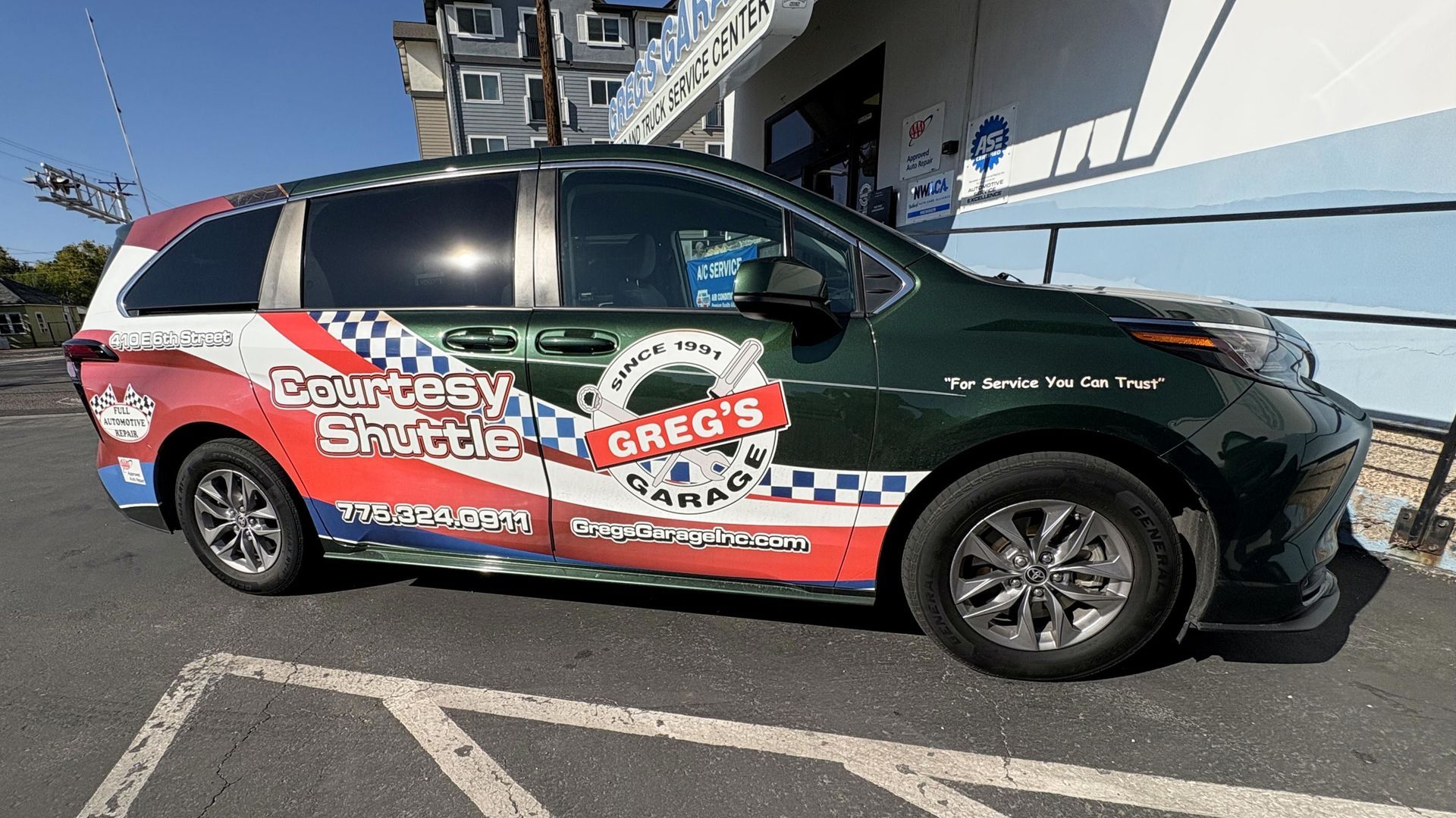Green, red, and white minivan with 