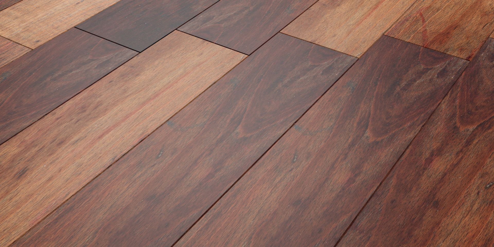 Close-up of a wood floor with alternating light and dark brown planks