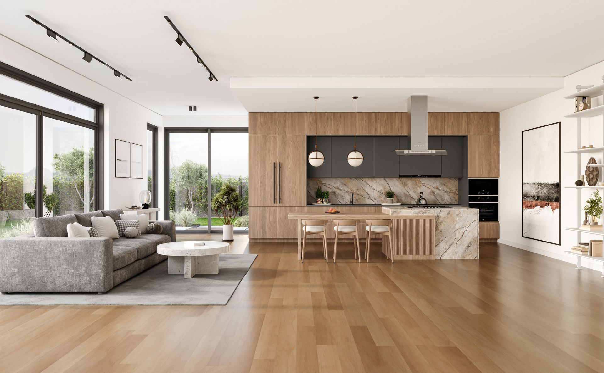 Bright modern open-plan living room with gray sofa, wood floors, and kitchen island with pendant lights