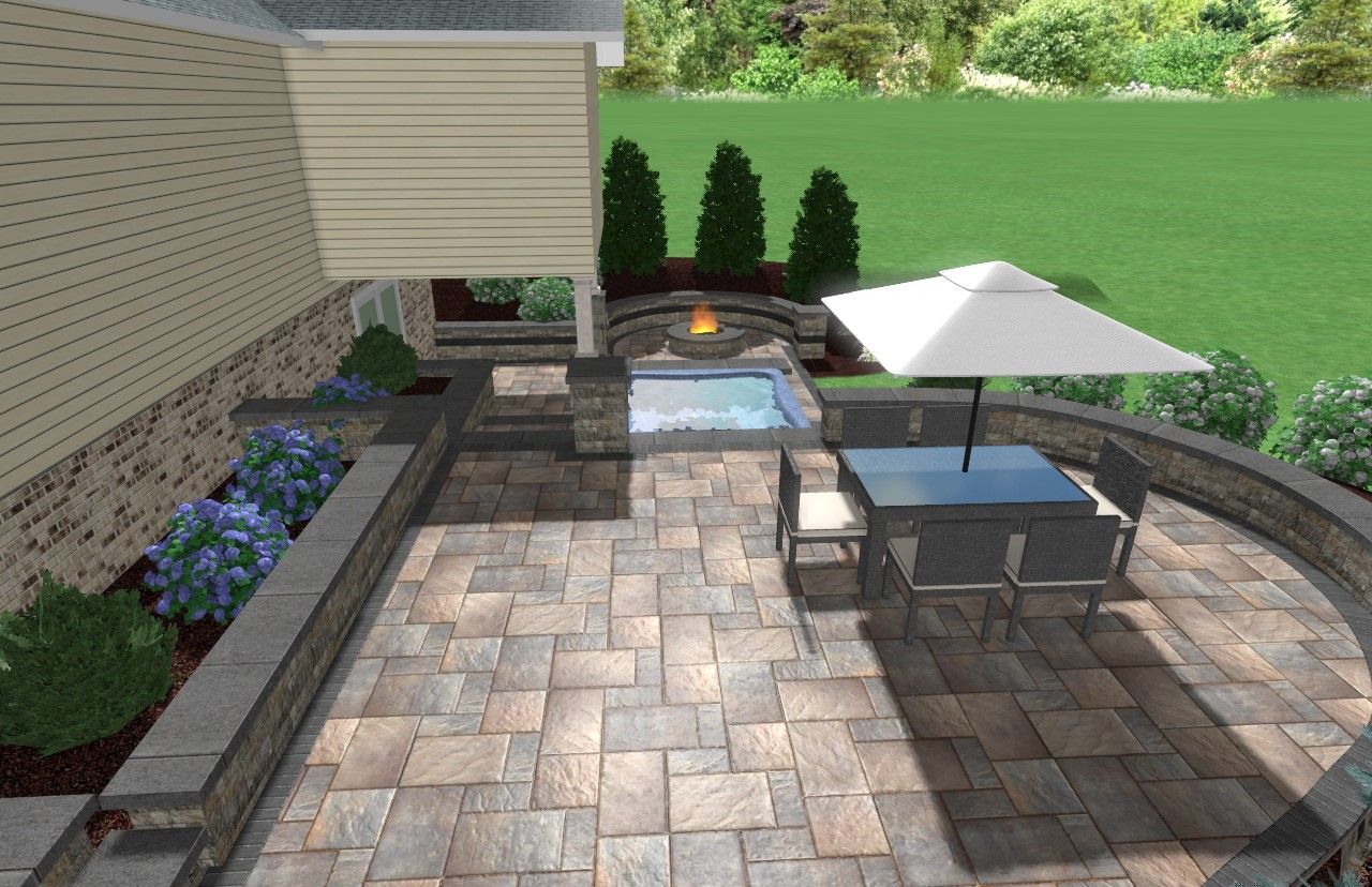 Patio with a hot tub, dining set, and landscaping, beside a light beige building.