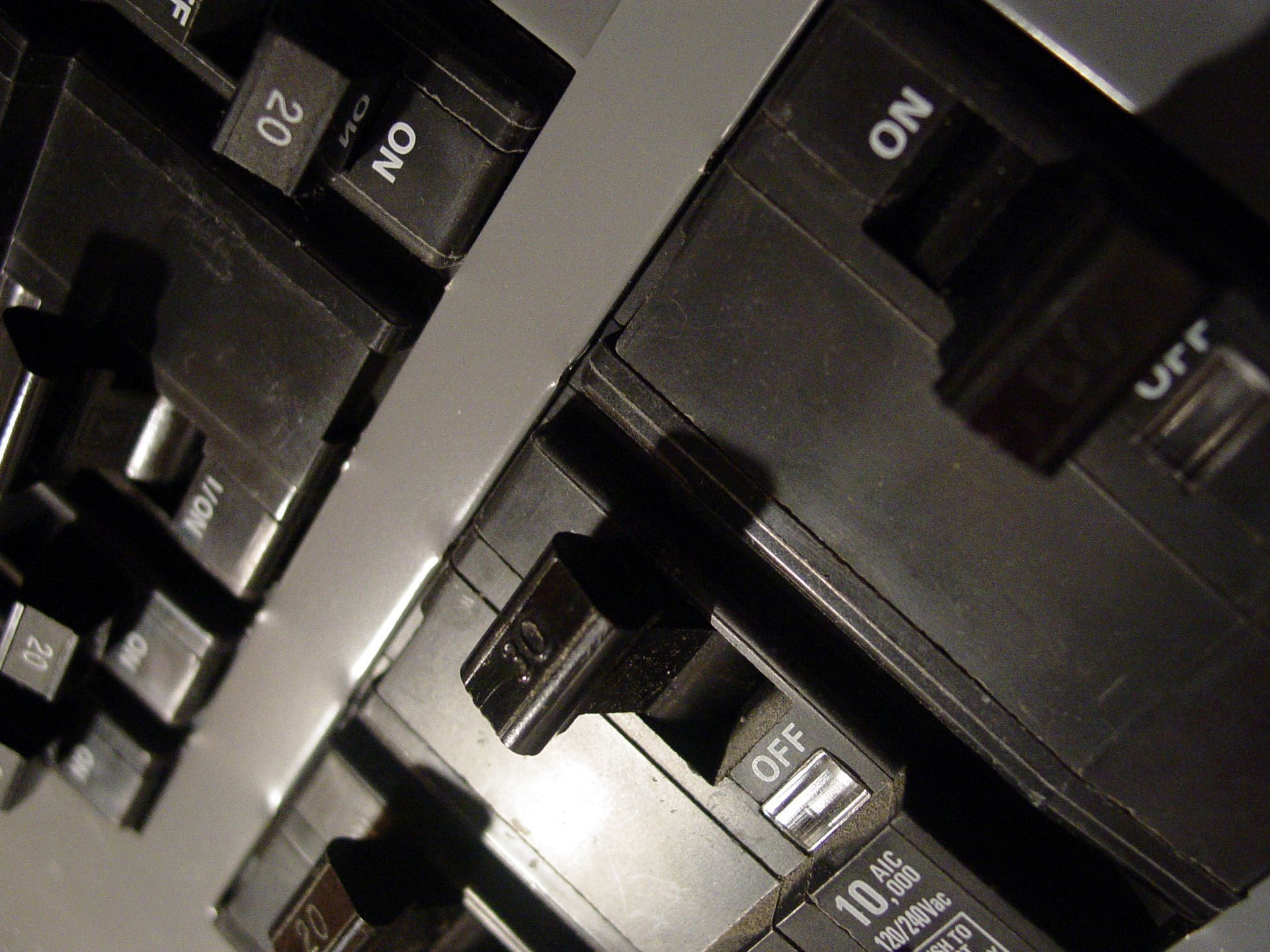 A close up of an electrical box with a lot of wires coming out of it.
