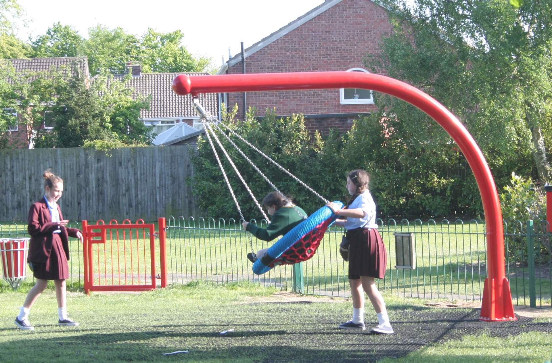 Child Pushed on Playground Swing