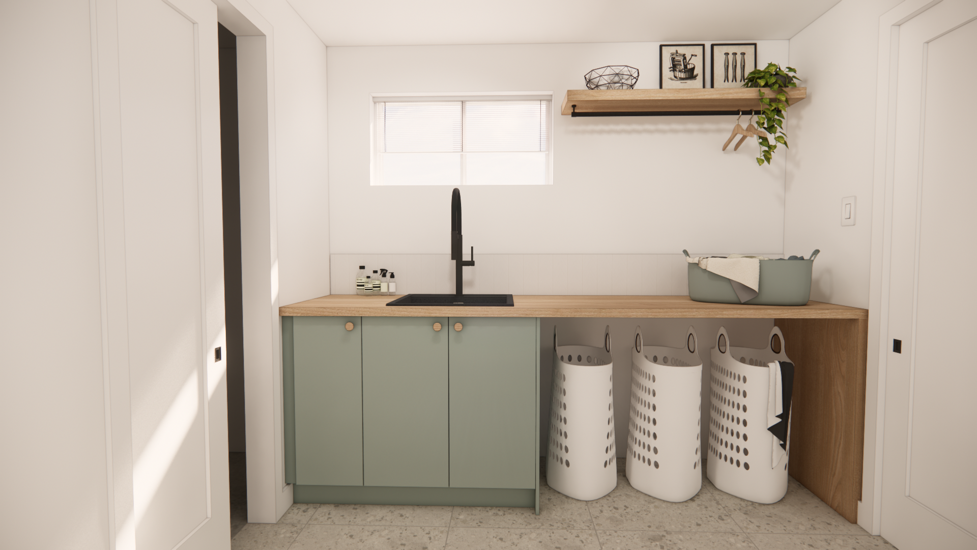 Buanderie avec placards couleur sauge, plan de travail en bois, évier et paniers à linge.