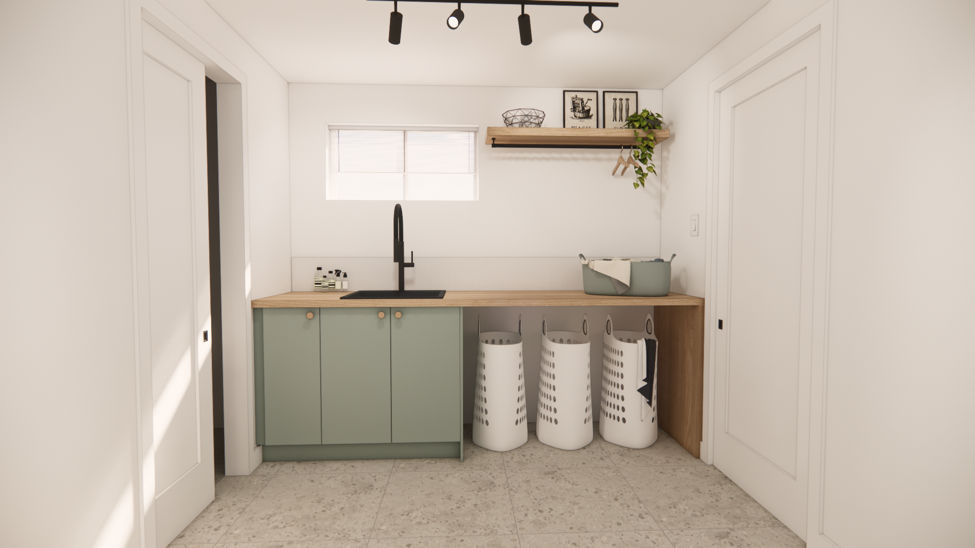 Buanderie avec placards vert clair, plan de travail en bois, trois sacs à linge et petite fenêtre.