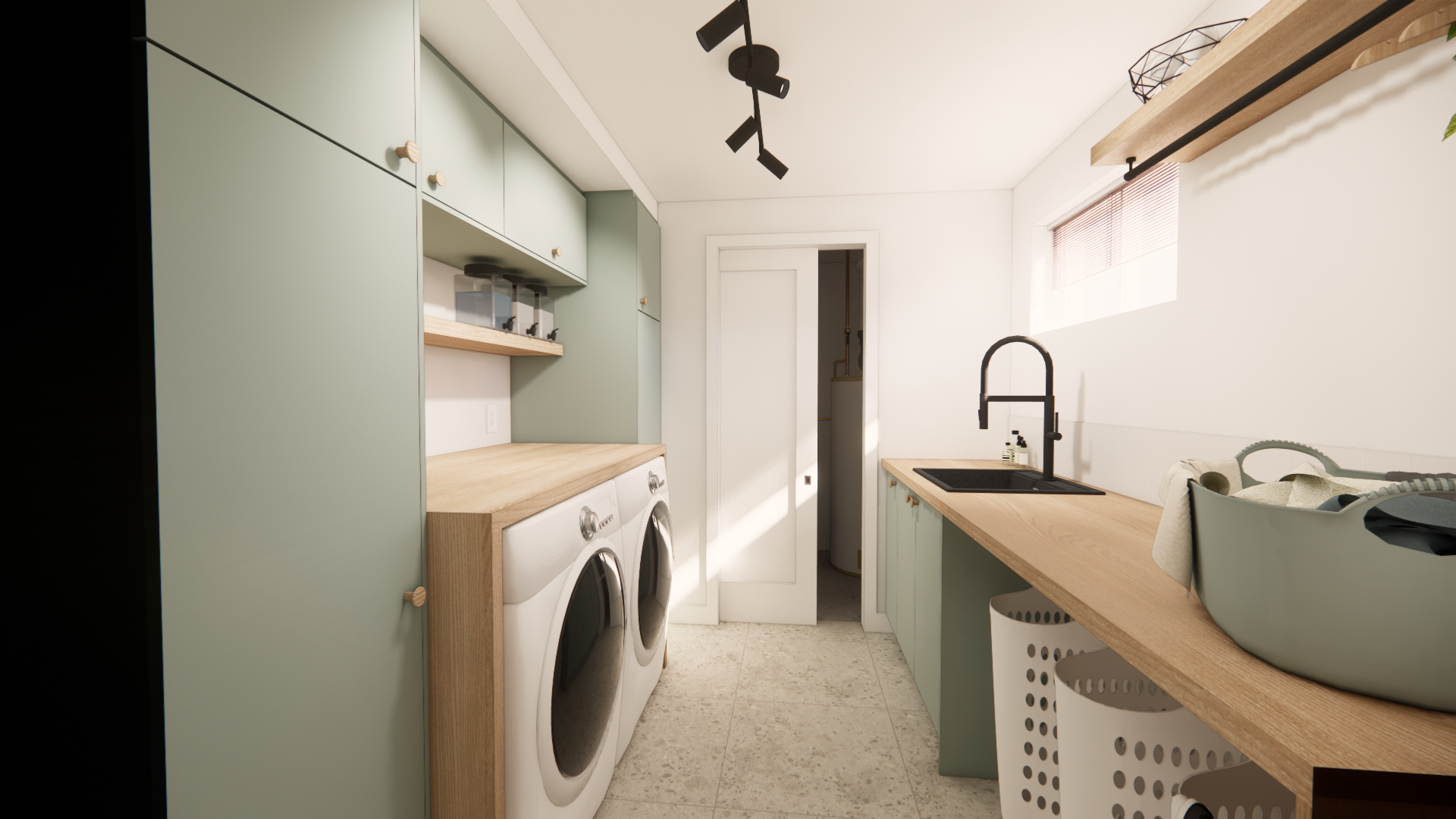 Buanderie avec placards vert clair, comptoirs en bois et appareils électroménagers blancs.