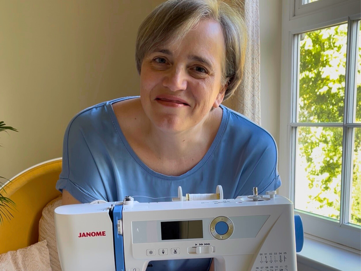 Lisa Walters sat behind a sewing machine, smiling