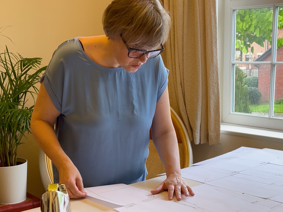 Lisa Walters looking at sewing patterns on a sewing table