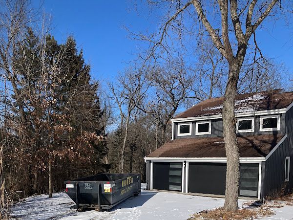 A dark grey house with a two-car garage.
