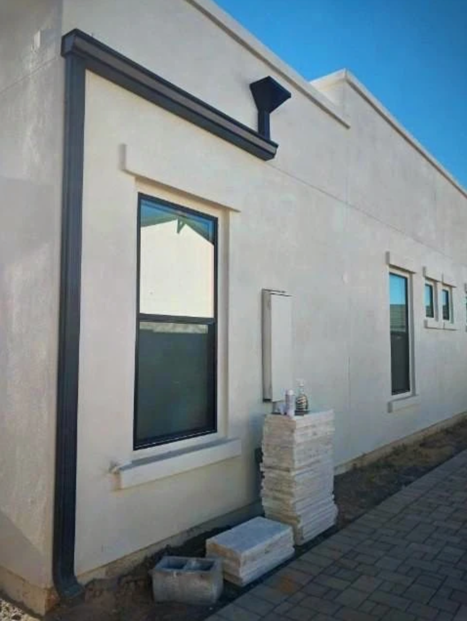 A person is working on an electrical box with a screwdriver.